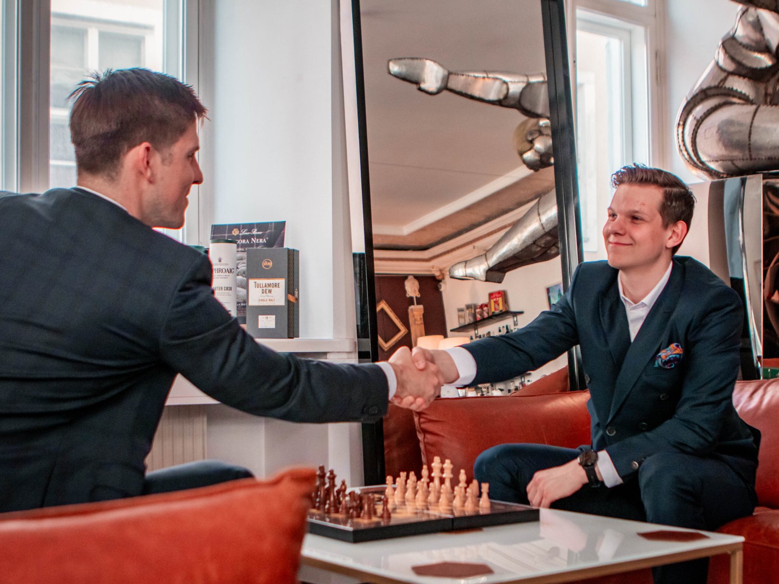 Marcus Pertelson and Aleksei Garanin, Hathor Productions founders, handshaking before chess match